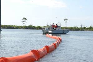 NAVAL AIR STATION PENSACOLA, Fla. - Naval Air Station Pensacola Pollution Response unit deploys an oil containment boom at Sherman Cove to protect environmentally sensitive grass beds from the Deepwater Horizon oil spill, May 4, 2010. U.S. Navy photo by Patrick Nichols. 